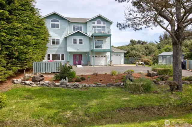 The first things one will notice upon arrival are the lovely landscaping in the front, ample parking, and a green house!