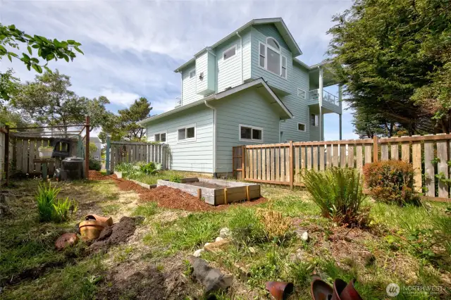 The SE corner of the property along/behind the garage space is fenced in and turned into a garden area.
