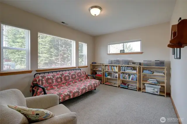 The first floor features a family room overlooking the front garden and firepit area.