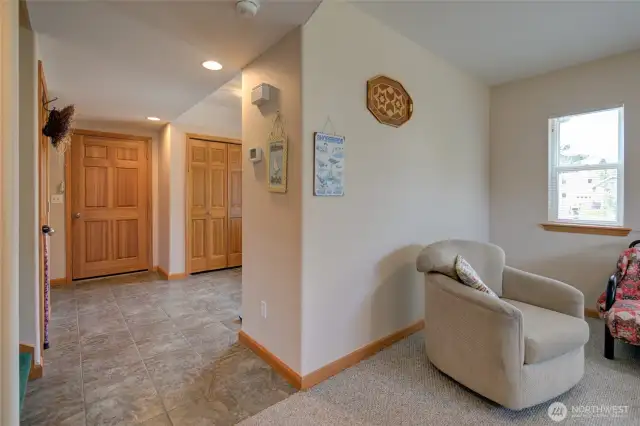 Turning back towards the main entry, the first floor is rounded out with a half bath, the staircase, the elevator, and the garage entrance.