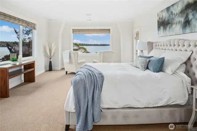 Wow! The primary suite is sweet indeed! When you enter the spacious bedroom, you see sweeping lake views through the large windows. The window in the center of the photo has been a favorite space to relax and watch boats, float planes, and the resident eagles and other wildlife. Imagine waking up to this every day!