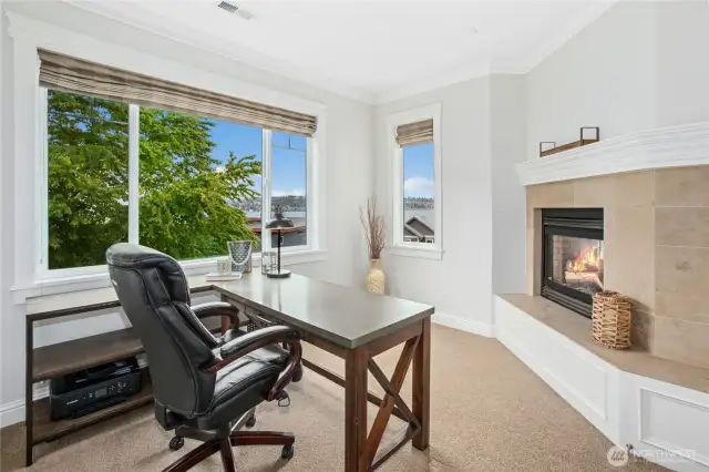 The private office on the upper floor is just off the primary bedroom and features awesome lake and mountain views as well as a cozy gas fireplace (the dual-sided fireplace is shared with the primary bedroom).