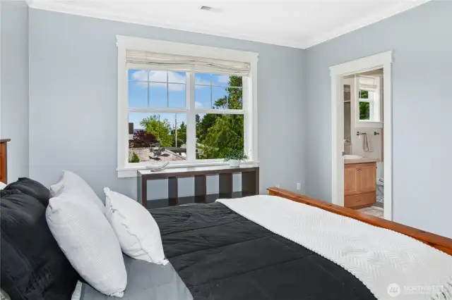 This large bedroom on the upper level has plenty of space for dressers and shelving, along with an ensuite bath.