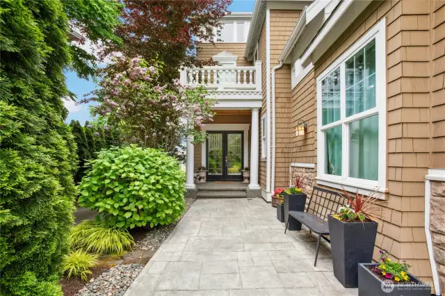 What a welcoming entrance with lovely landscaping and a covered front porch.