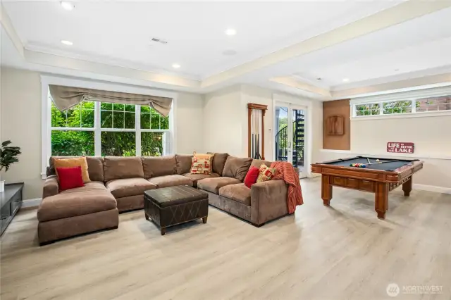 This spacious rec room was completely renovated in May 2025 and is a wonderful place to hang out, play pool (pool table is negotiable), watch television and relax. Note door with spiral staircase to take you up to the main floor kitchen or to the upper level primary suite view deck. Flooring is luxury vinyl tile...ideal for wet feet coming in from the lake!