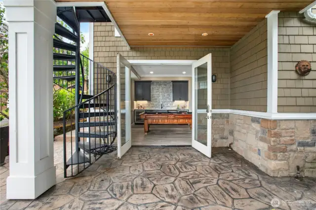 This covered stamped-concrete patio with French doors looks directly into the new rec room. The sidewalk on the left of this photo (the north side of the home) leads you straight down to the lake. There is a convenient storage area on the back of the home for your stand-up paddleboards, furniture, etc.  This home has fantastic storage options!