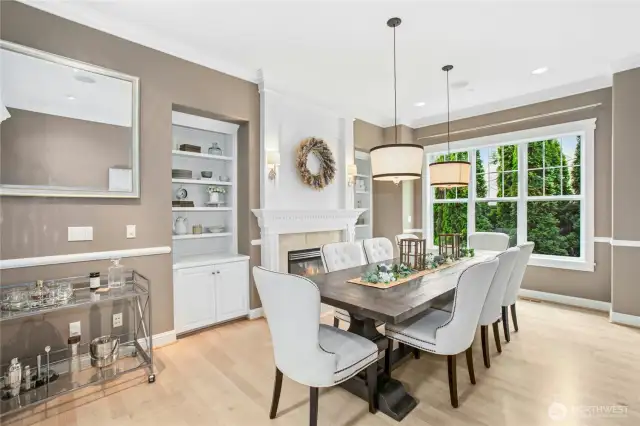 The formal dining room has a gas fireplace, built-in cabinetry with shelves for displaying your treasures and ample space for entertaining.
