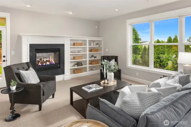 Second living space with another gas fireplace and door leading to covered patio.