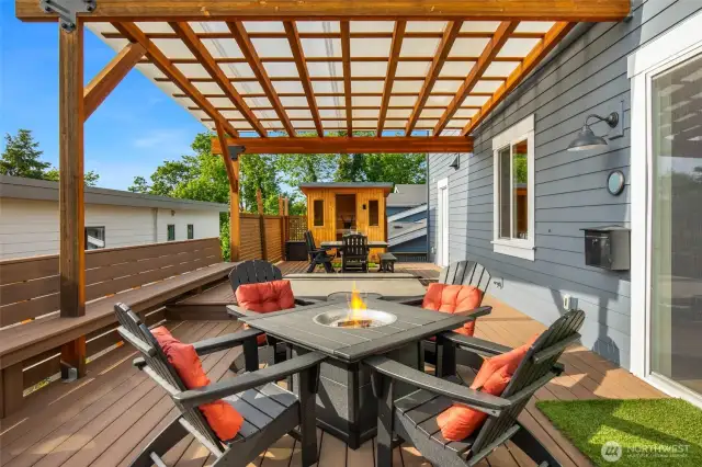 This outdoor space has it all! Firepit, sitting + dining area, hot tub and sauna. Deck also has built-in seating for all your guests.