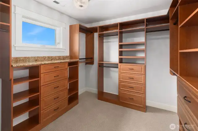 Large walk-in closet with custom built-ins.
