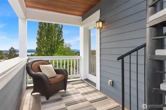 Terrace of the primary suite with stairs leading up to the rooftop deck.