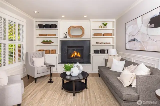 Living room with built-ins and cozy gas fireplace.