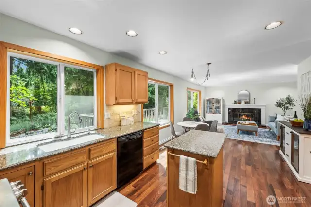 Open Concept kitchen with island, granite counter tops, under cabinet lighting and the gorgeous hardwood floors