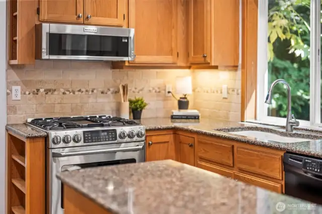 Open Concept kitchen with island, granite counter tops, under cabinet lighting and the gorgeous hardwood floors
