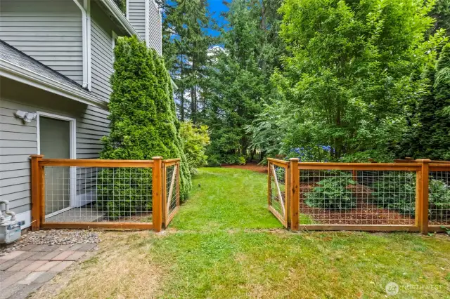 Beautiful fence borders the property. New in 2024.