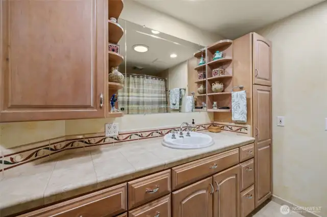 Full Hall bath on main floor with solar tube and cabinet space.