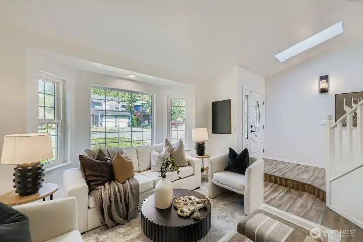 Vaulted ceiling living room with skylights.