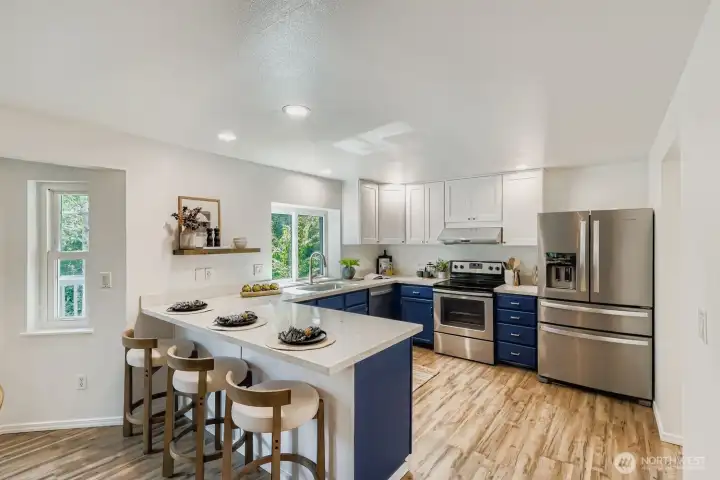 Open concept kitchen with quartz counters.