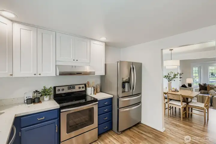 Open concept kitchen with quartz counters.