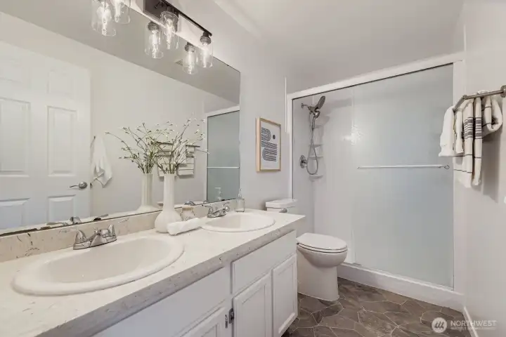 Primary en-suite bath with quartz counters.