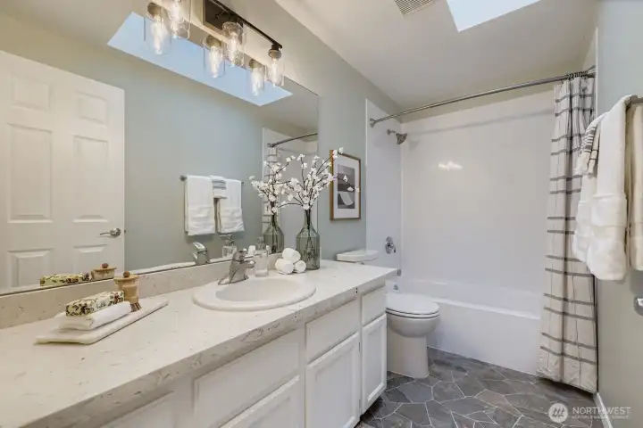 Main upstairs bathroom with quartz counters.