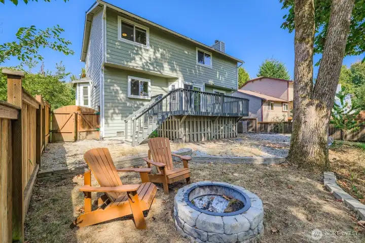 Backyard with firepit overlooking the greenbelt.