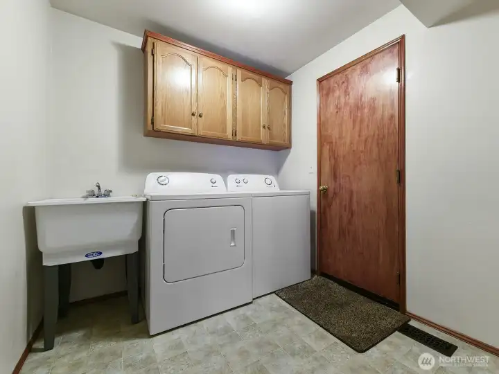 Main Floor utility room. Washer and Dryer go with sale. Washing sink and extra cabinets.