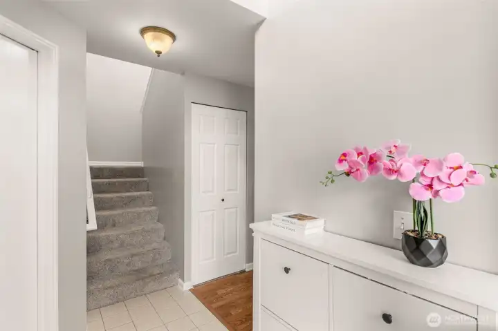 Spacious 2 car garage is to the left of the staircase