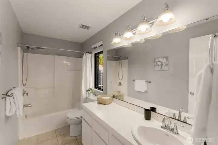 Upstairs hall bath is light and bright