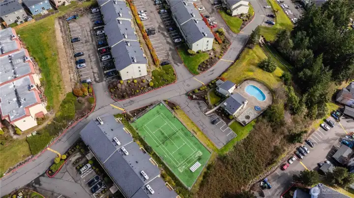 Over head view of the condo amenities, enjoy the sport courts, outdoor pool, hot tub and private dog parks.