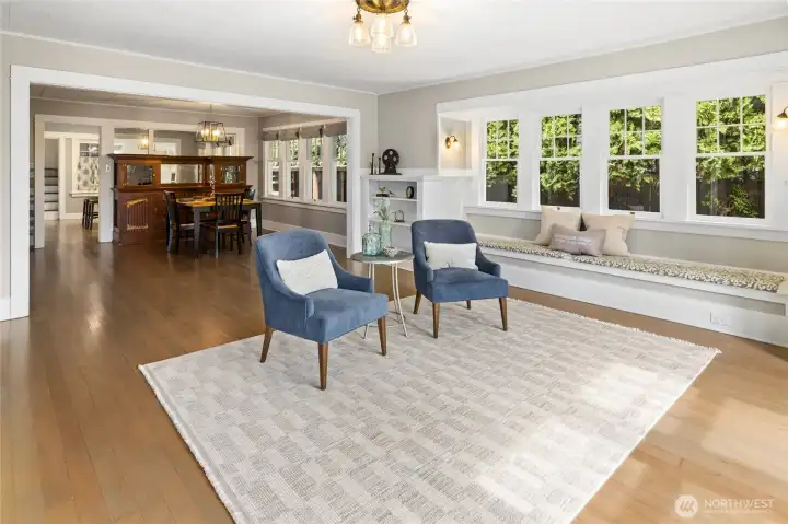 Living room has large bay window seating area with storage. Original Fir Floors have been refinished and look beautiful!