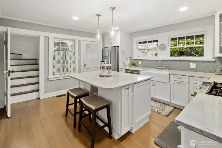 Your Chef inspired Kitchen! New Gas Range, new appliances, farmhouse style sink, large island, quartz countertop and soft close cabinetry.