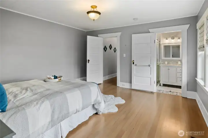 Your Primary Bedroom looking into primary bathroom. Original Real Wood Doors throughout the home.