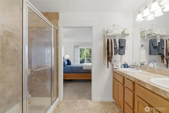 Ensuite primary bathroom with double vanity and walk-in shower.