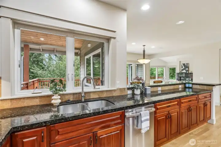 Another view from the kitchen to the back patio and dining.