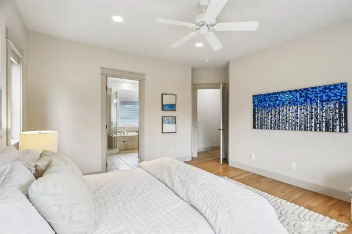 Another view of the primary bedroom featuring nice walk in closet with separate hook ups for washer and dryer on the main floor as well as lower floor!
