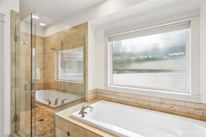Deluxe master bath featuring fully tiled nice size walk in shower with soaking tub!