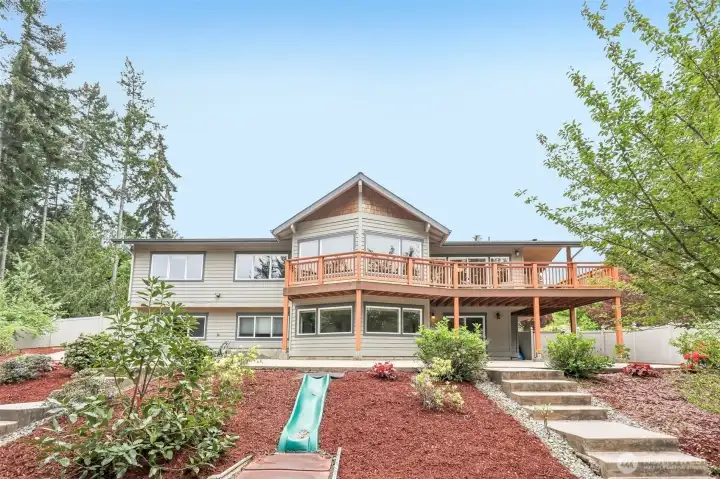 View of the home from the Backyard!  Large covered decks for year round use!