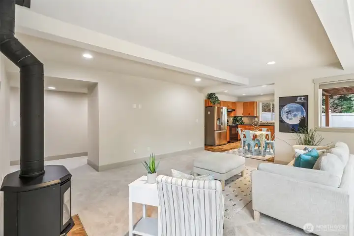 Another view from the downstairs family room to the full kitchen with eating space!  Did we mention separate laundry room downstairs.