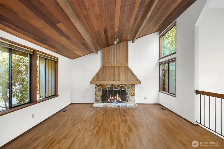Family room with grand wood burning fireplace.