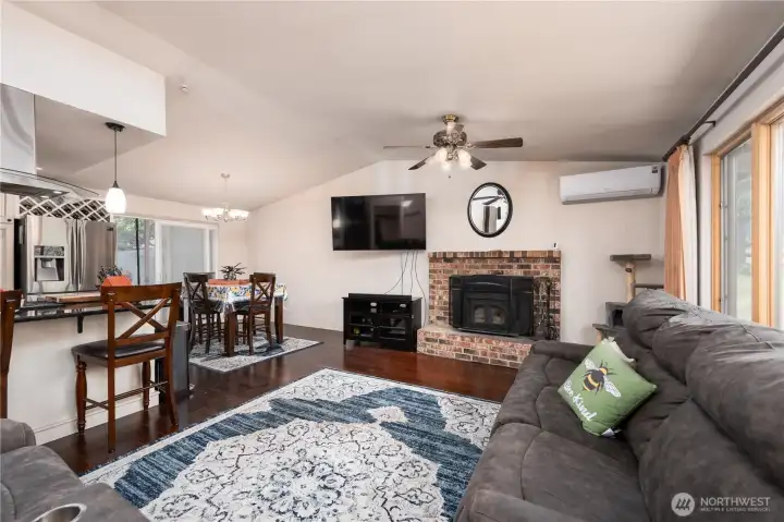 Open concept living room, dining room and kitchen with island.
