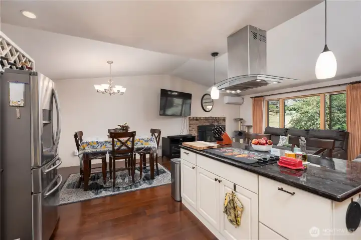Island with cooktop range, looking into dining room and living room