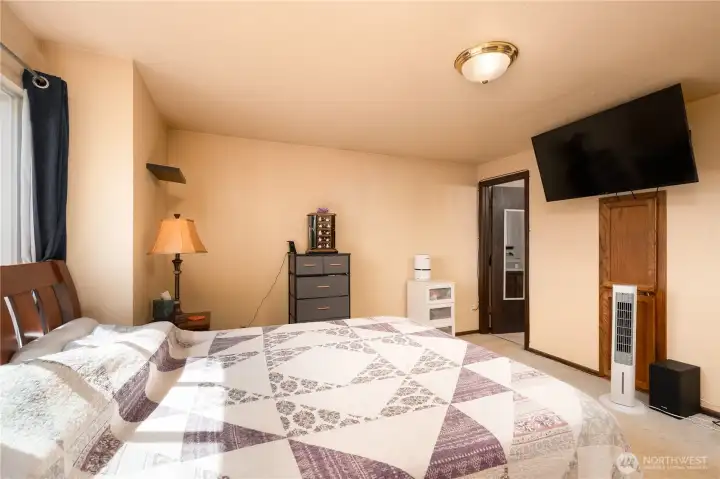 Primary bedroom and door to primary bathroom