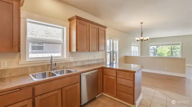 Kitchen also features window above the sink, built-in cutting board and countertop seating.