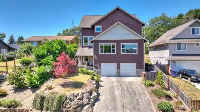 Great curb appeal with mature landscaping & large two-car garage.