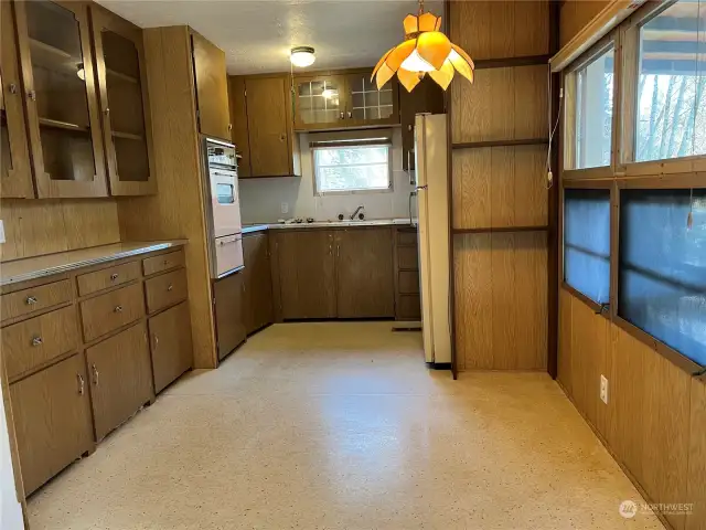 Kitchen has a new cooktop and enjoys views of the Greenspace from the front windows.