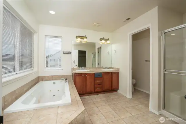 Soaking tub, shower and two sinks are what greets you in your primary bathroom
