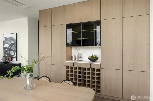 High-end custom cabinetry features Bavaria Oak wood veneer, custom wine storage, lighting and push-to-open cabinets