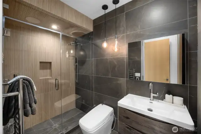 Steam shower, bluetooth speakers, bidet, complete with a towel warmer.