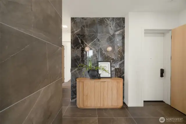 Entry features a double entry door and a stunning marble wall.